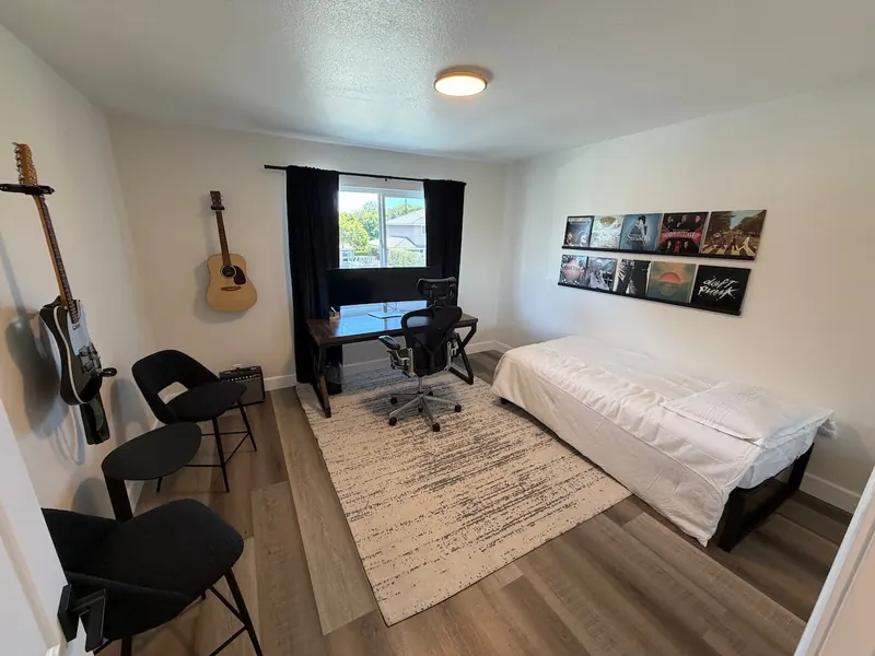 Bedroom with desk and guitars