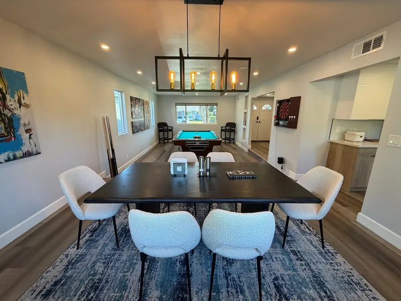 Dining table for the whole group, game room beyond
